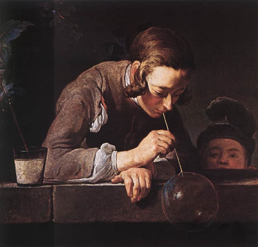 A young man leans on a stone ledge blowing a soap bubble as a child watches.