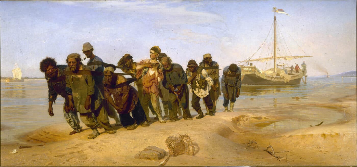 Eleven ragged men harnessed to a towline haul a barge along the Volga.